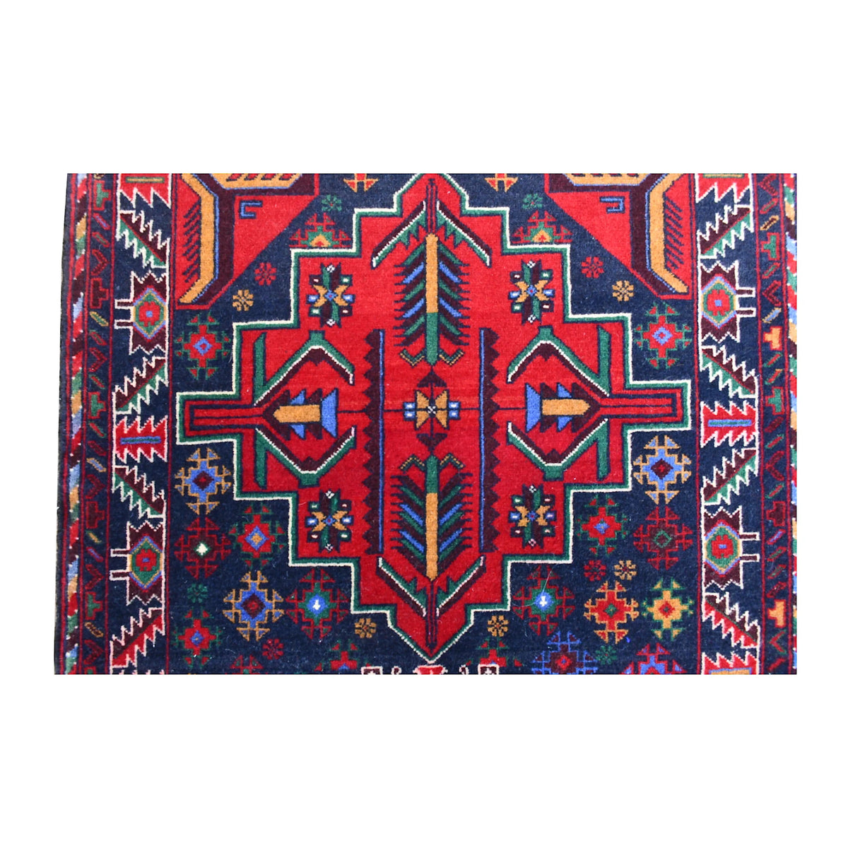 Close-up of Baluchi runner showing a large red central medallion with teal, ivory and dark geometric outlines