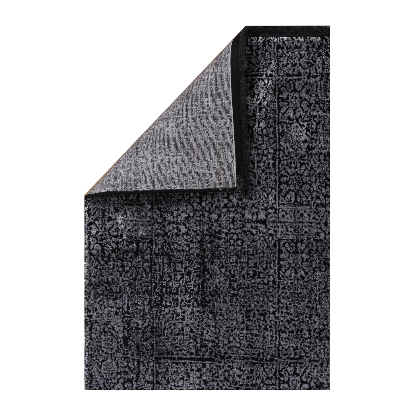 Folded corner detail of Brooklyn 100 silver mosaic rug showing edge and backing texture