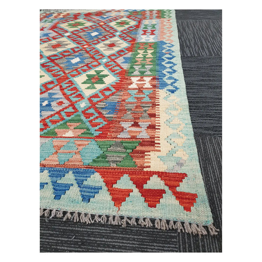 Angled detail of Afghan Chobi Kilim showing fringe, border pattern, and handwoven flatweave texture, 156 x 106 cm
