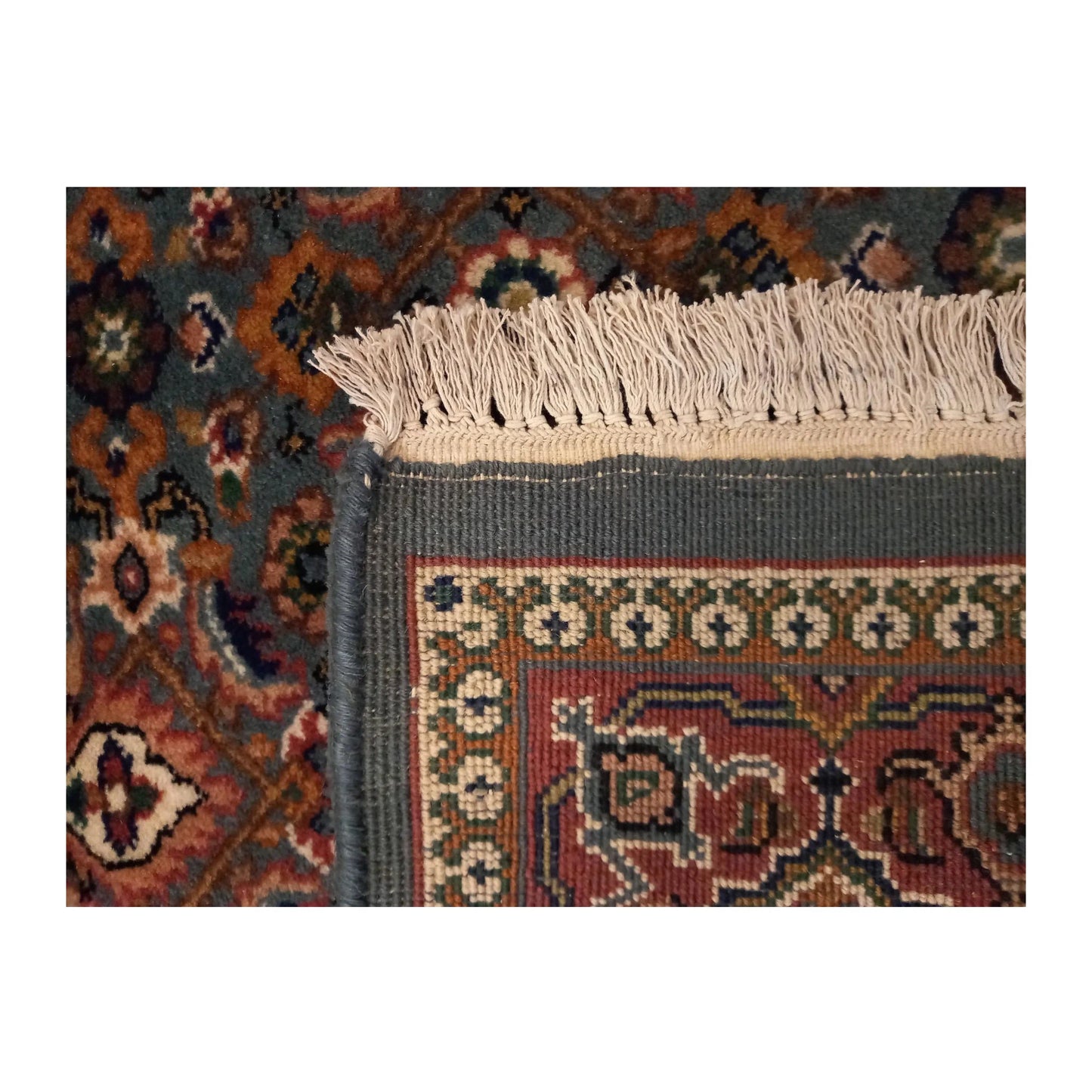 Folded-corner detail of Fine Bidjar rug showing the floral border, rug edge and visible fringe