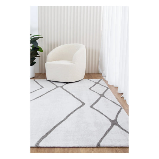 Grace ivory grey trellis rug styled with cream chair and soft natural light