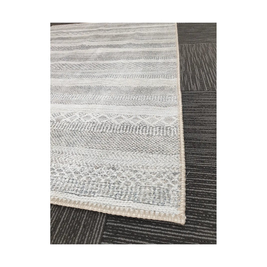 Close-up of grey ivory geometric stripe cotton rug corner and border detail