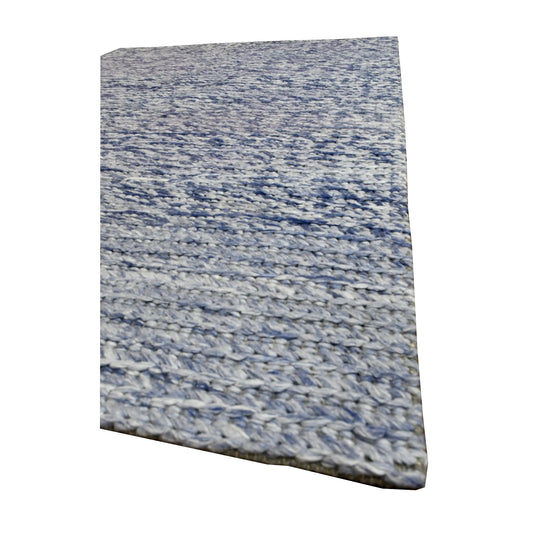 Angled view of Harlow blue hand-tufted wool rug showing its thick textured pile, tonal variation and finished edge