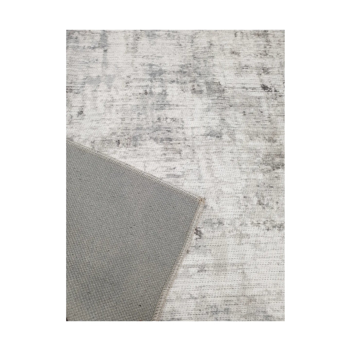 Close-up of ivory grey cotton rug corner with back and edge detail