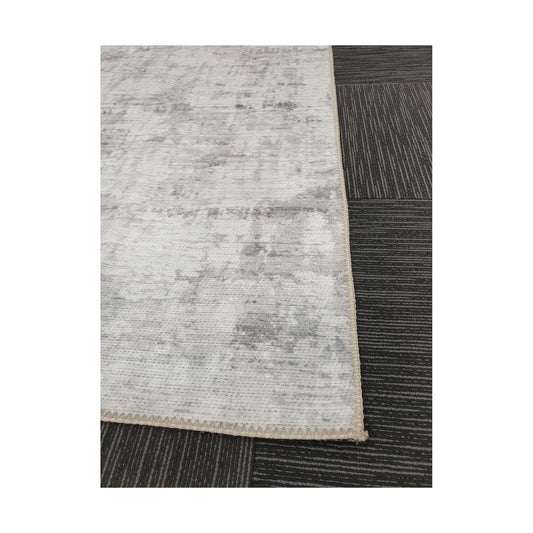 Close-up of ivory grey cotton rug corner with edge and surface detail