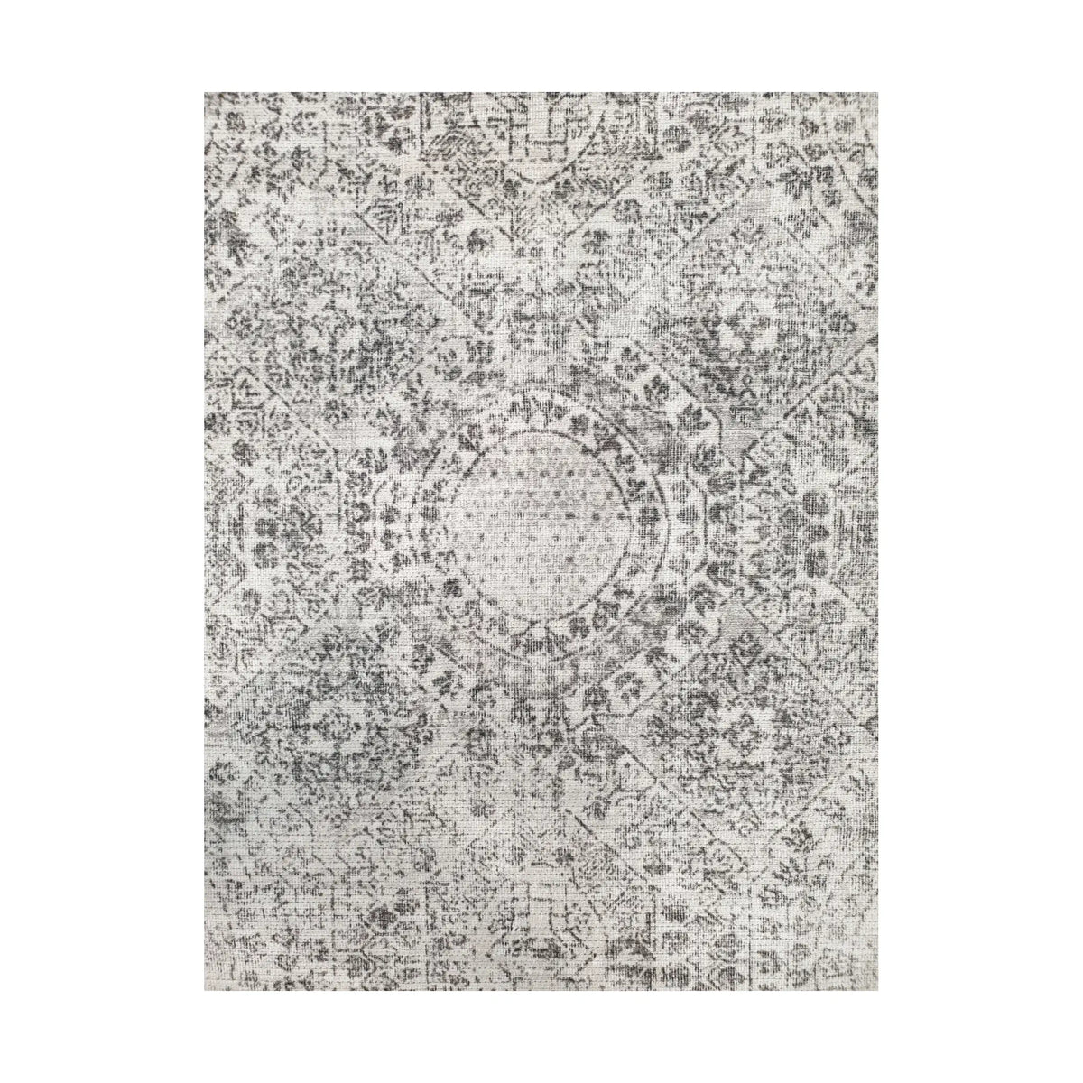Close-up of ivory grey cotton rug central medallion and ornamental floral pattern