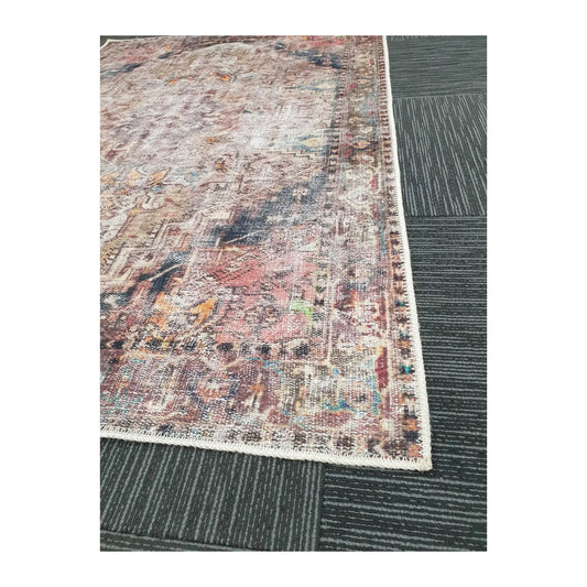 Close-up of ivory teal rust cotton rug corner with faded ornamental border detail