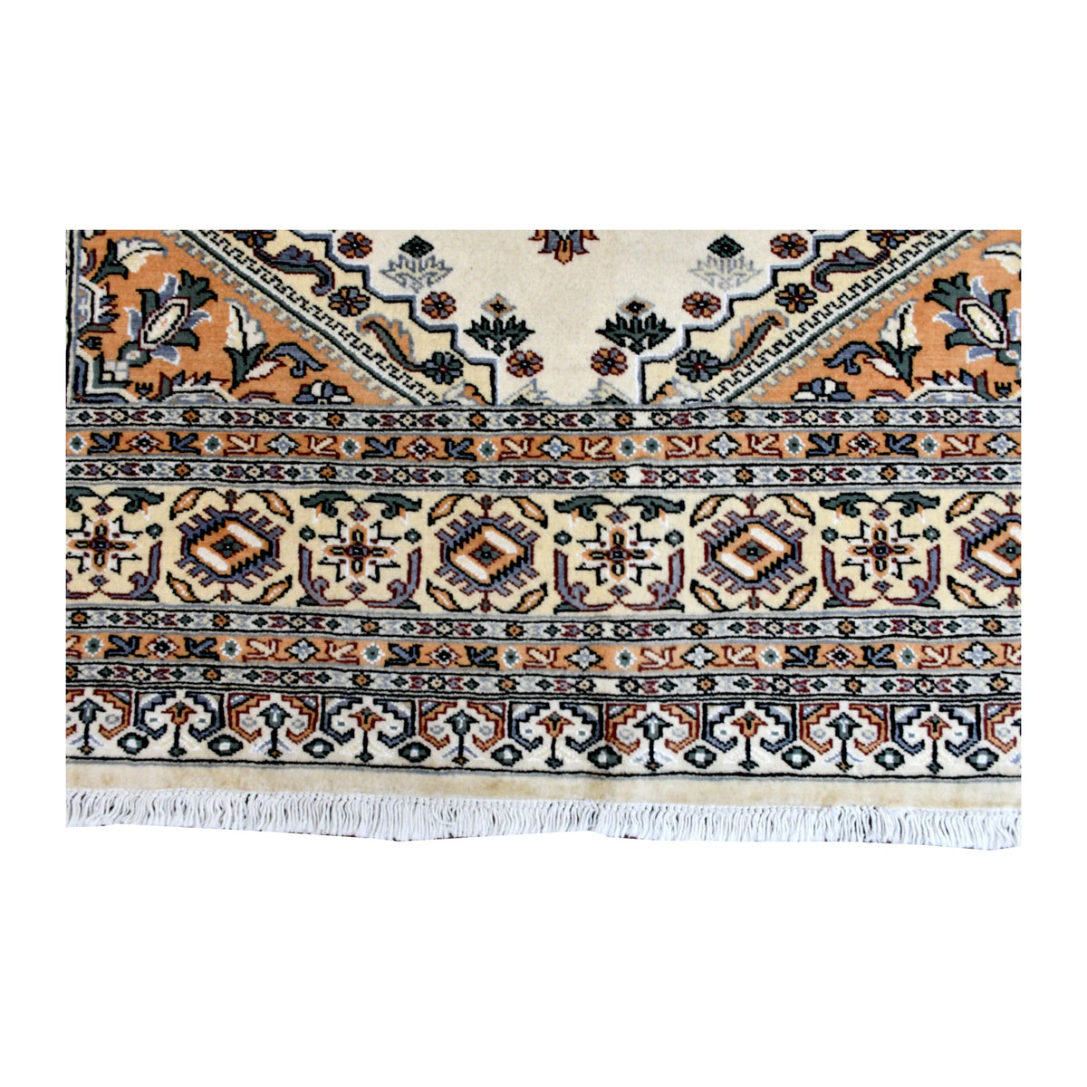 Fringe and end-border detail of Jaldar rug with warm beige, rust-orange, blue-green and deep charcoal geometric motifs