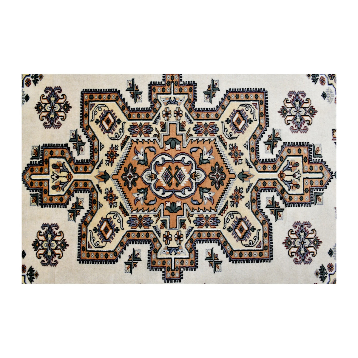 Close-up of Jaldar rug’s geometric medallion with a rust-orange centre, deep charcoal outlines and muted blue-green accents