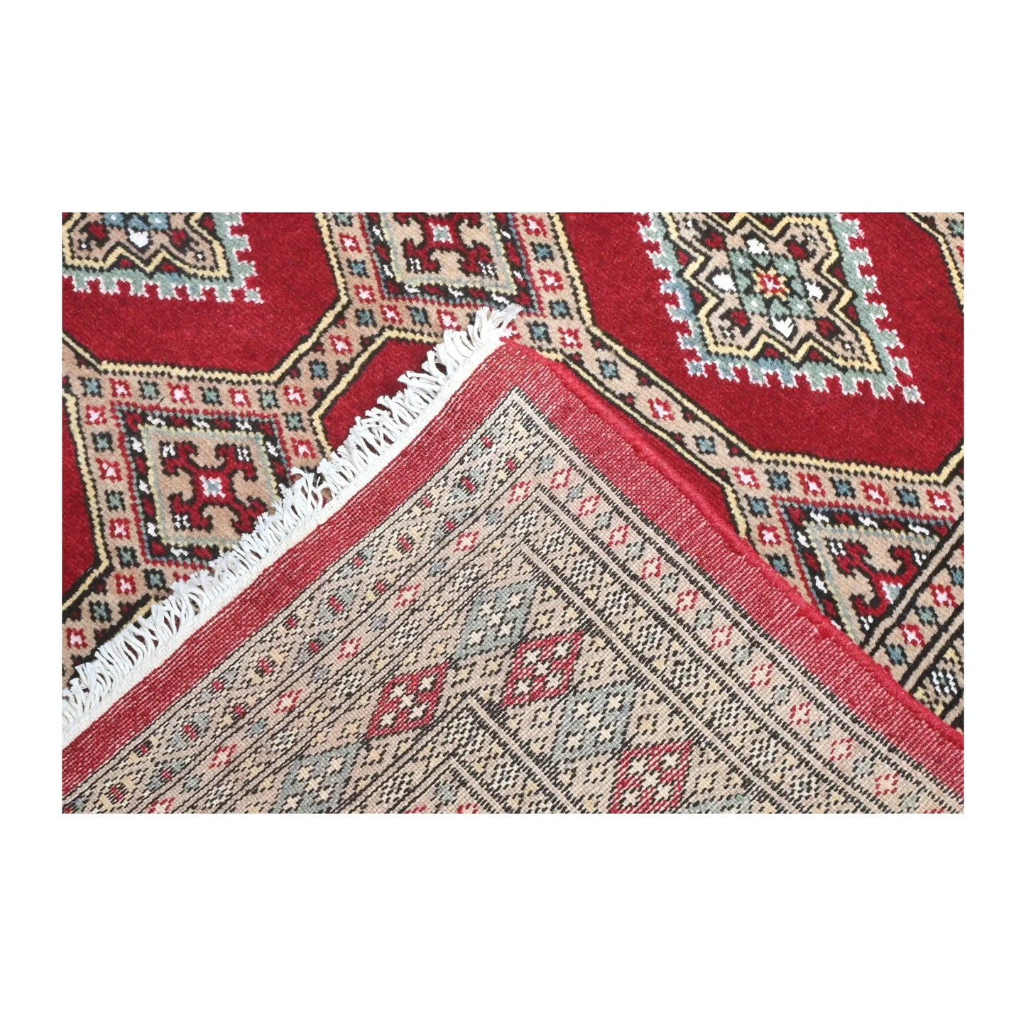 Folded-corner detail of Jaldar rug showing the patterned field, reverse weave and visible fringe