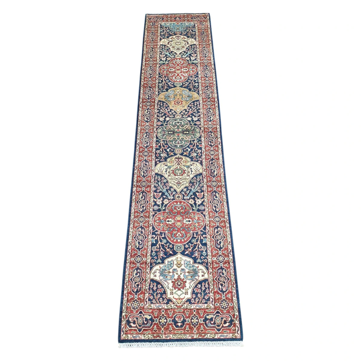 Khurjeen hand-knotted wool runner rug 352 x 81 cm shown in full view with red and navy geometric medallion design
