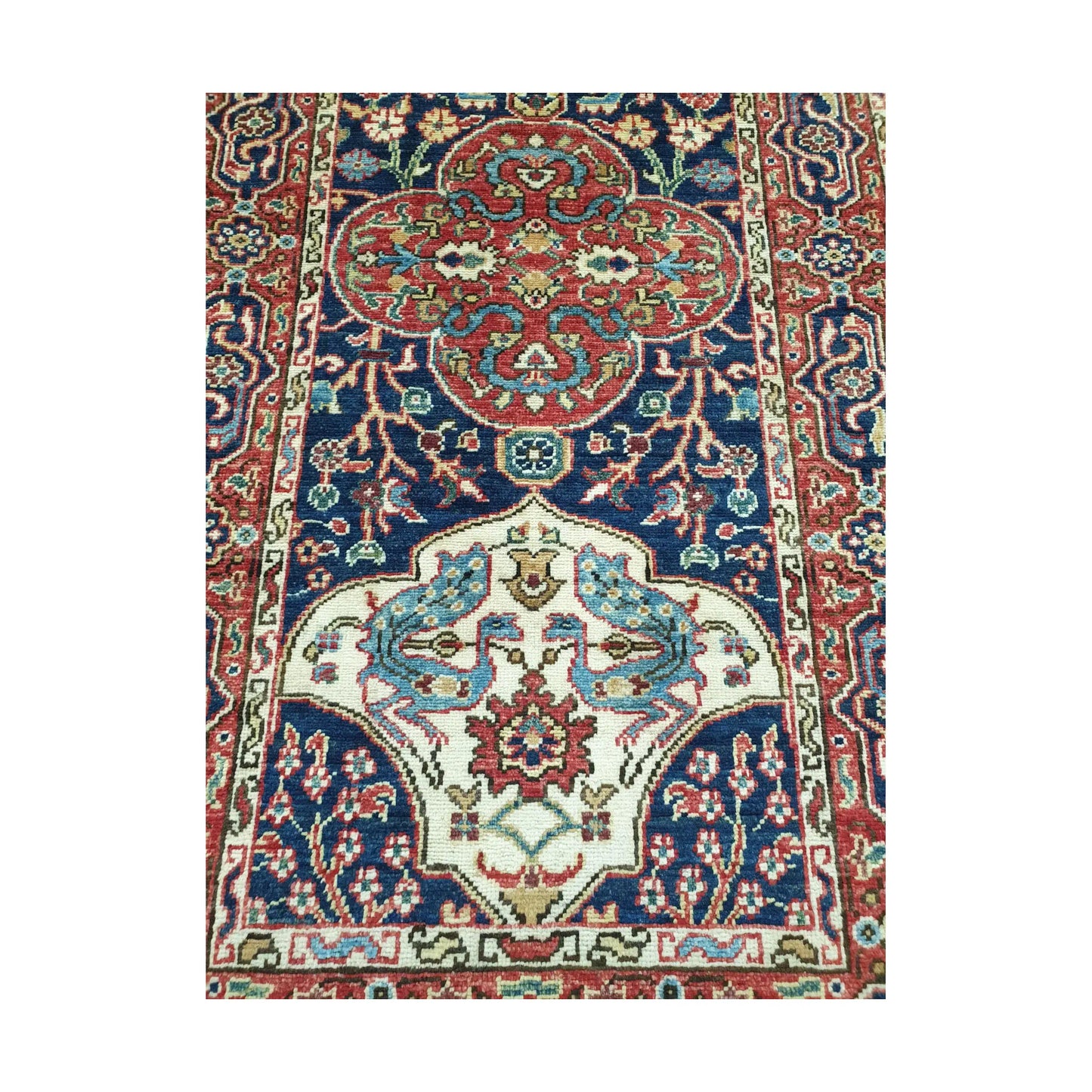 Close-up of Khurjeen runner rug medallion pattern with red, navy blue, ivory and rust geometric detail