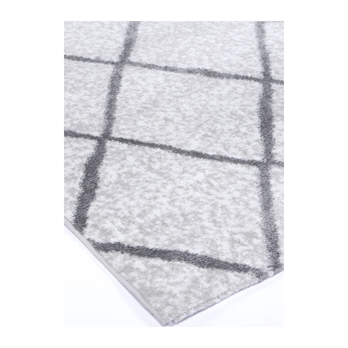 Corner detail of Kimberley 1 Trellis Silver rug showing bound edge, pile texture and diamond pattern, 290 x 200 cm