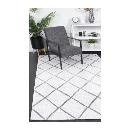 Kimberley 1 Trellis Silver rug styled with chair and indoor décor, showing modern grey trellis design, 290 x 200 cm