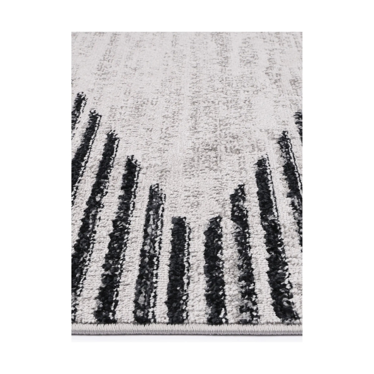 Edge detail of Kimberley 3 Diamond Charcoal rug showing heatset polypropylene pile, charcoal stripe detail and soft texture, 230 x 160 cm