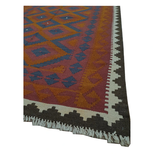 Corner border and fringe detail of Mamina Kilim wool rug with maroon field, navy diamond motifs and cream tribal border, 243 x 160 cm