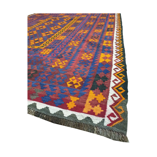Angled fringe and border detail of Mamina Kilim wool rug showing purple blue, yellow, orange and red flatwoven design