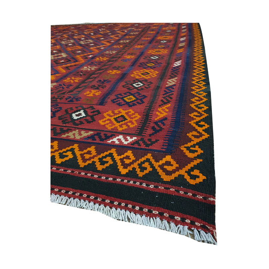 Angled fringe and border detail of Mamina Kilim wool rug showing red, navy, yellow and orange flatwoven pattern