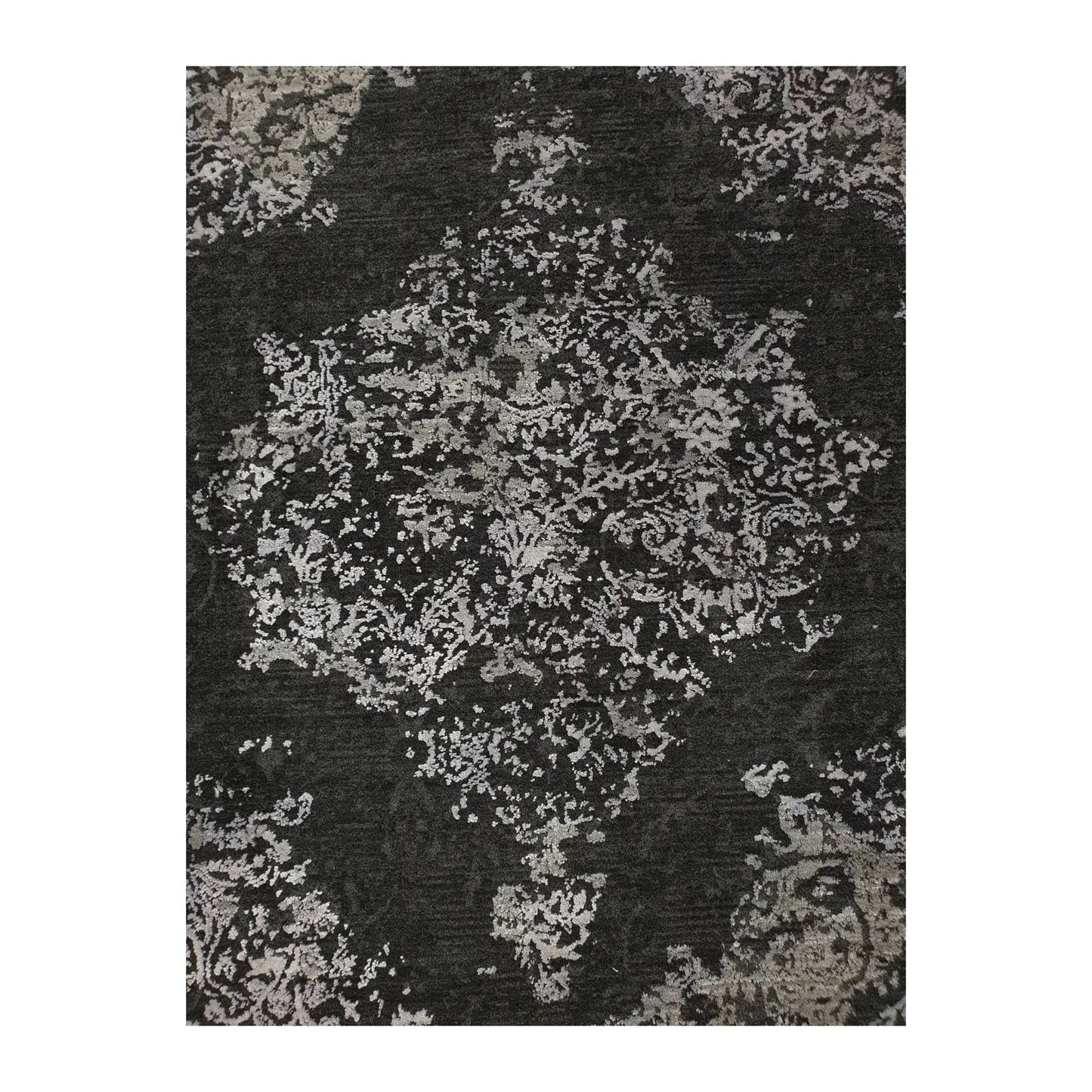 Close-up of round rug with silver and charcoal medallion design, 160 cm