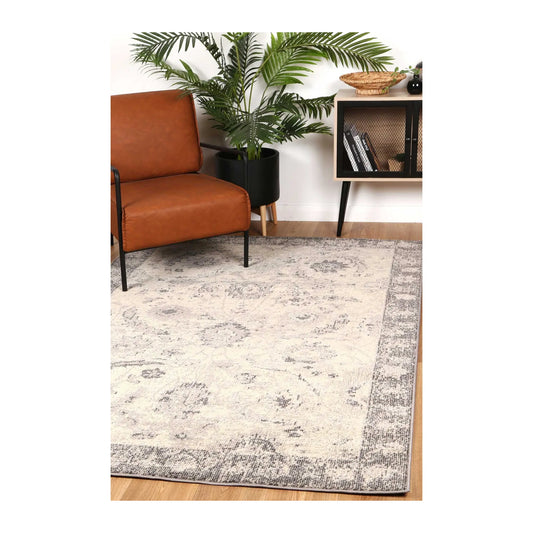 Tulin 12 Warm Cream and Grey transitional rug styled with chair and indoor décor, showing soft neutral pattern, 230 x 160 cm