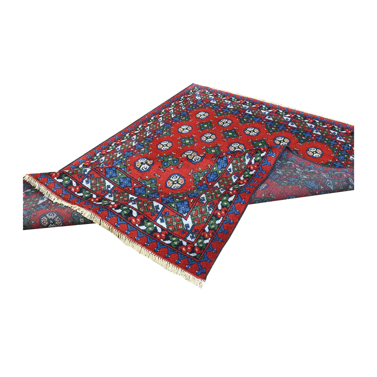 Folded view of Turkoman rug showing its patterned red pile, layered multicoloured borders and pale fringe