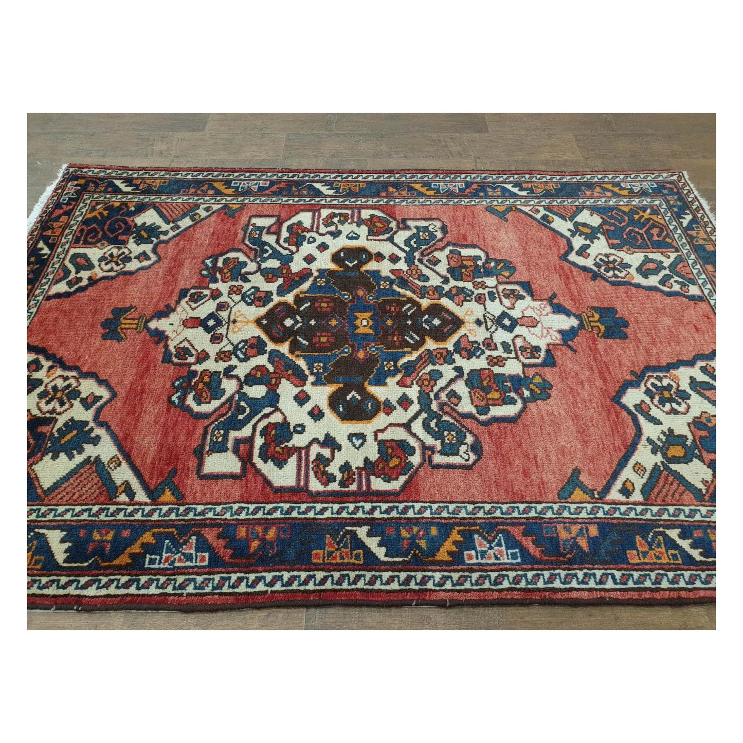 Angled full view of vintage Persian Hamadan rug showing medallion field and border