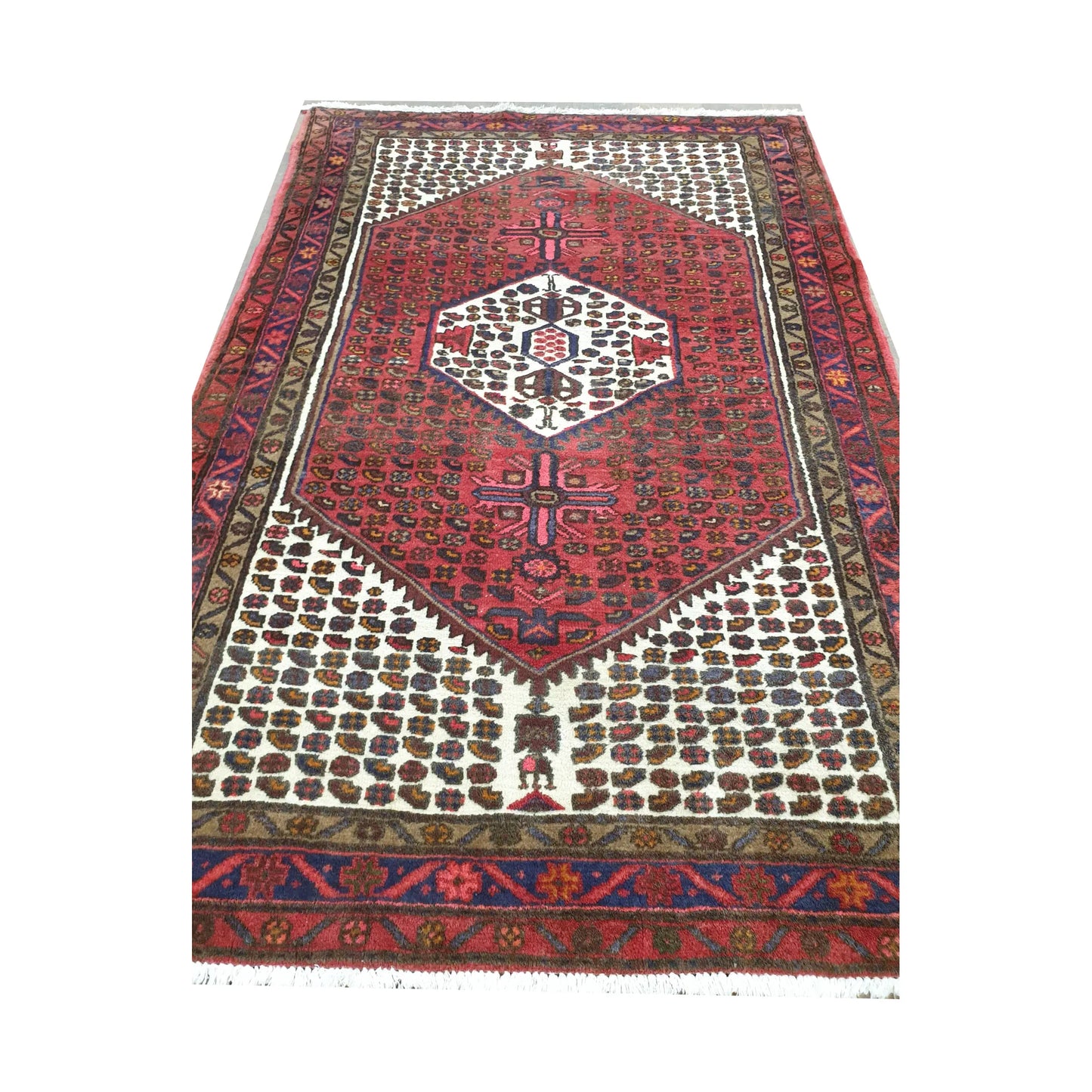 End detail of vintage Persian Hamadan wool rug showing geometric pattern and fringe
