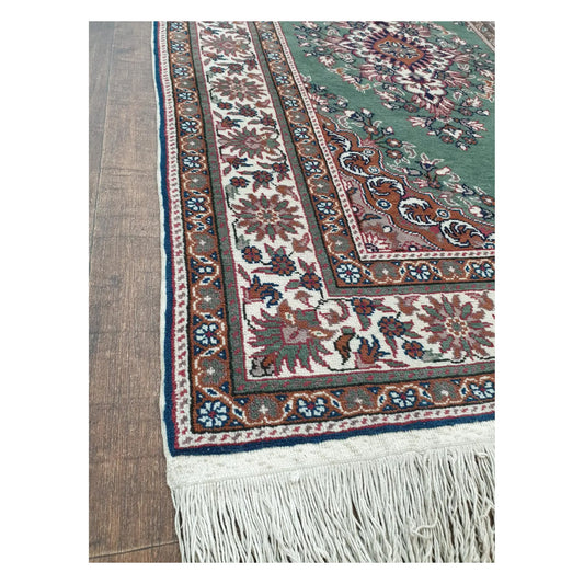 Border and fringe detail of a vintage Persian Tabriz fine rug showing floral motifs and hand-knotted wool texture