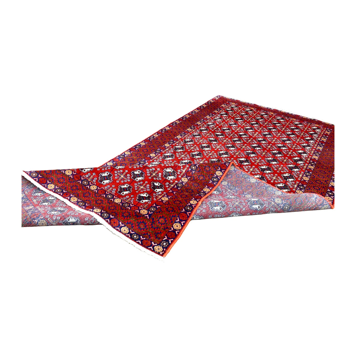Folded view of vintage Persian Turkoman wool rug showing its repeating gul field, layered borders and reverse