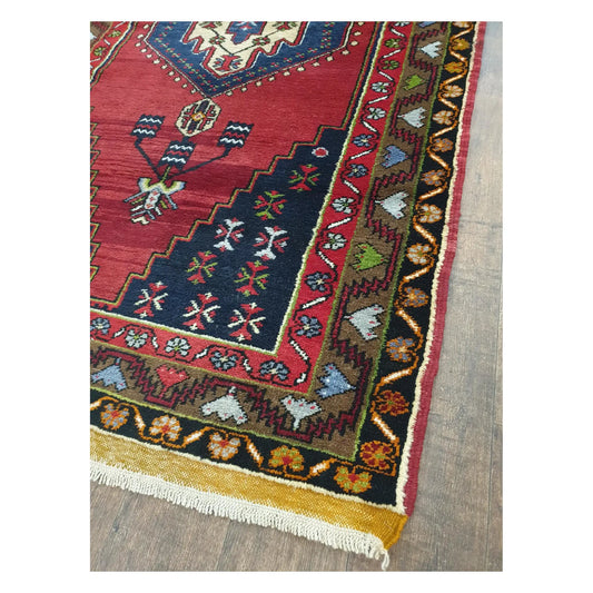 Border and fringe detail of vintage Turkish Yahyali wool rug with red and blue pattern