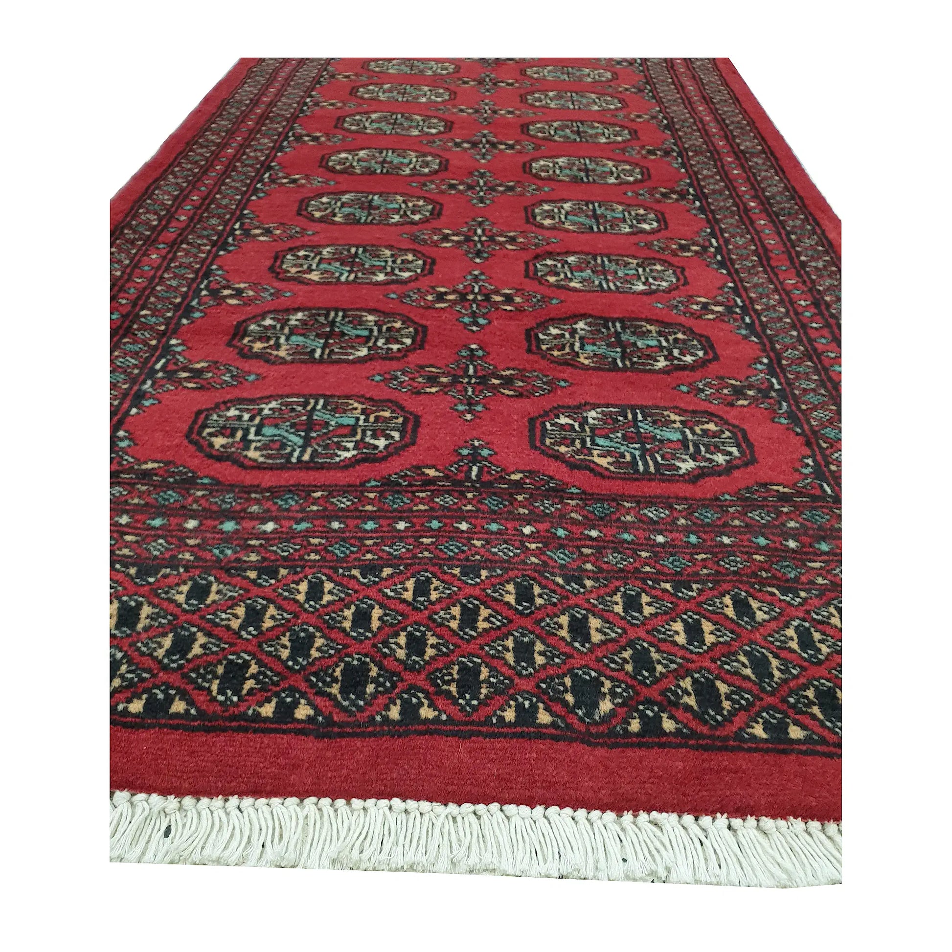 End field and fringe detail of Afghan Bokhara runner rug with red gul medallions and geometric end border