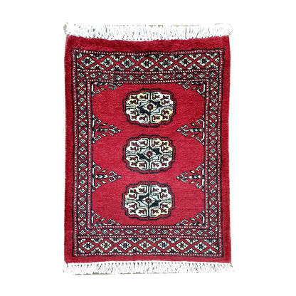 Afghan Bokhara wool rug 61 x 48 cm full view with red field, ivory gul medallions and fringe