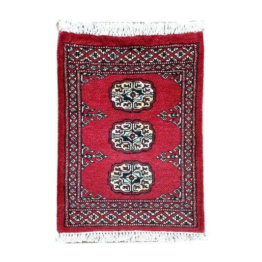 Afghan Bokhara wool rug 61 x 48 cm full view with red field, ivory gul medallions and fringe