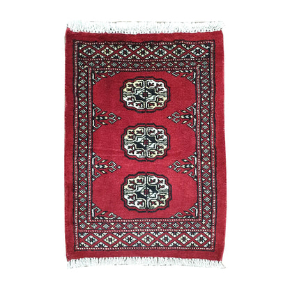 Afghan Bokhara wool rug 63 x 46 cm full view with red field, ivory gul medallions and fringe