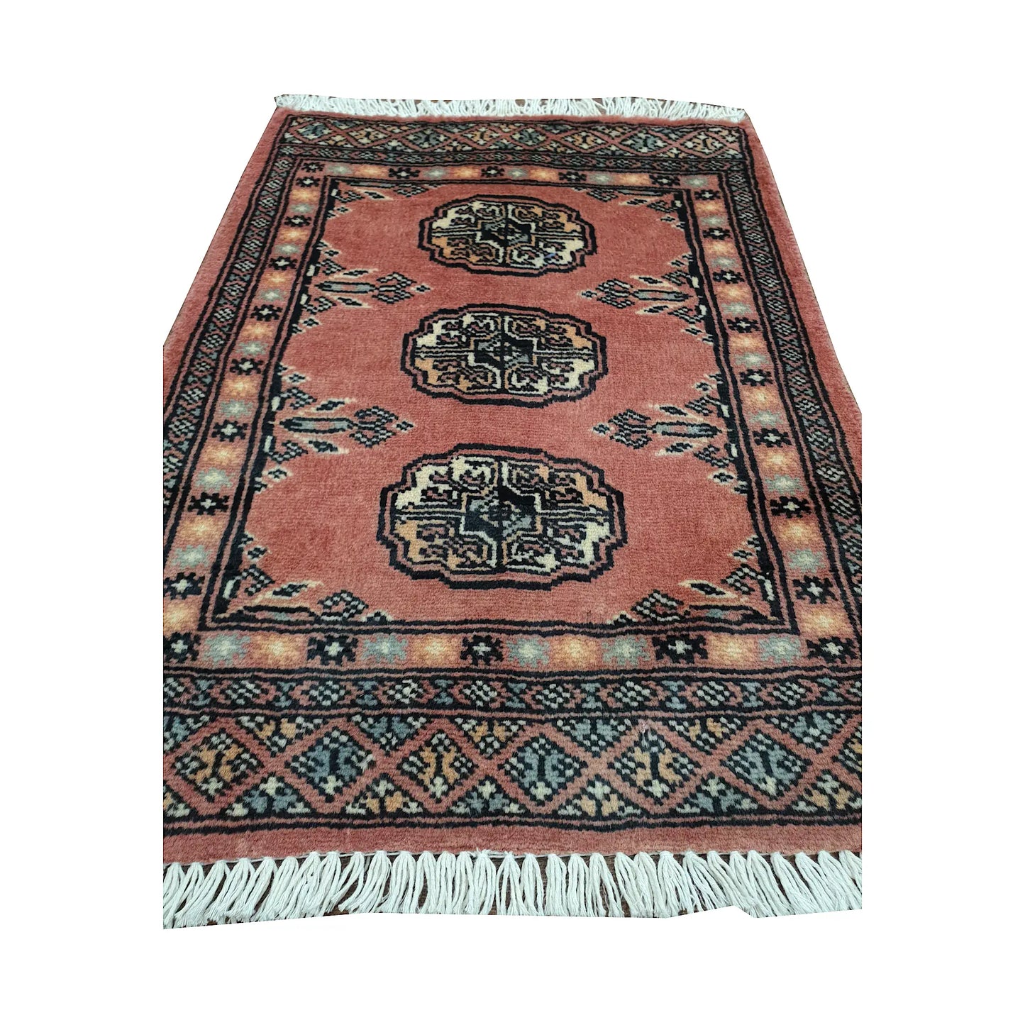 Salmon red field and border detail of Afghan Bokhara wool rug showing three ivory gul medallions and geometric border