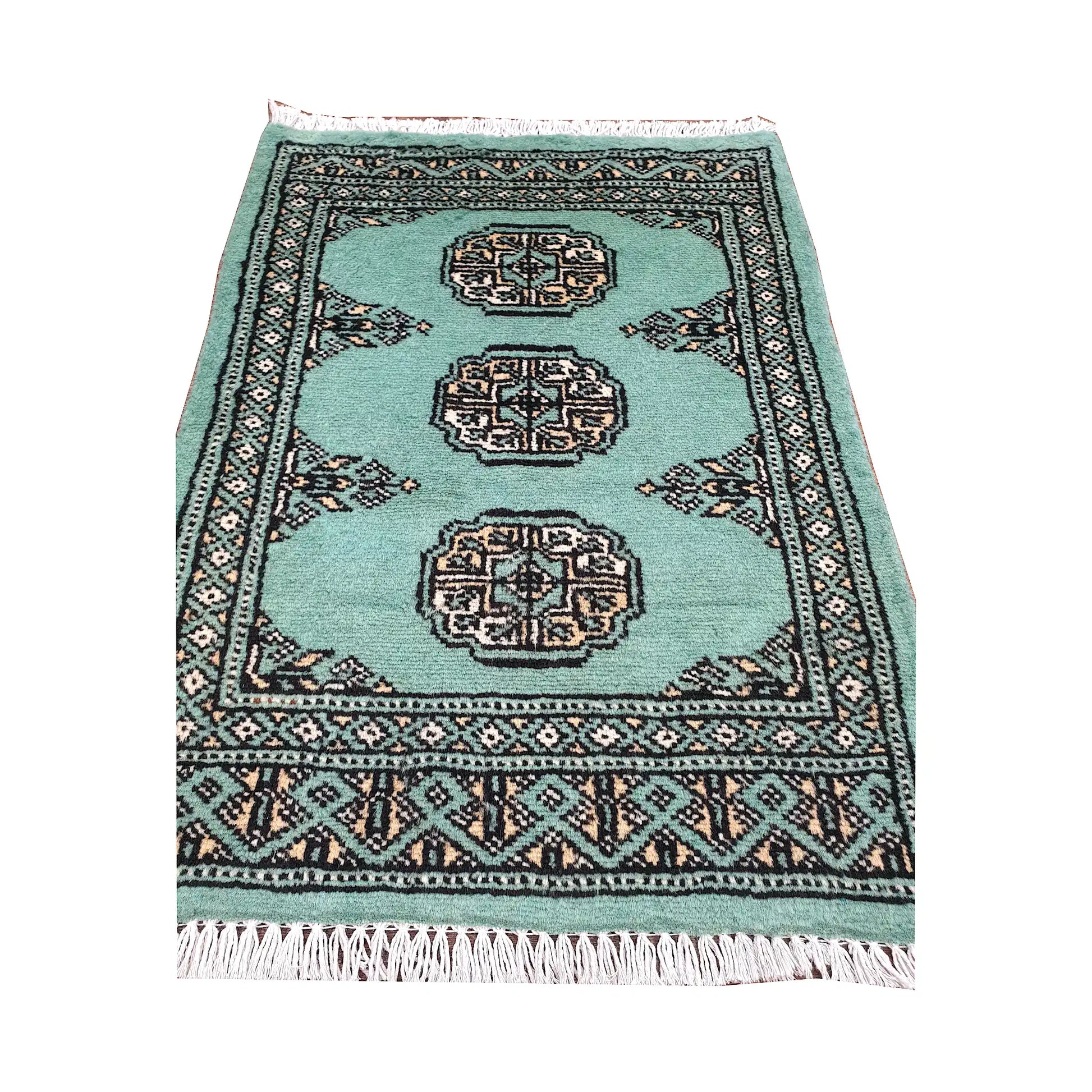 Light turquoise field and border detail of Afghan Bokhara wool rug showing three ivory gul medallions and geometric border
