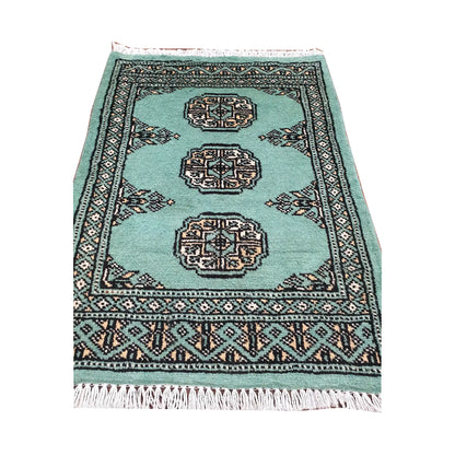 Light turquoise field and border detail of Afghan Bokhara wool rug showing three ivory gul medallions and geometric border
