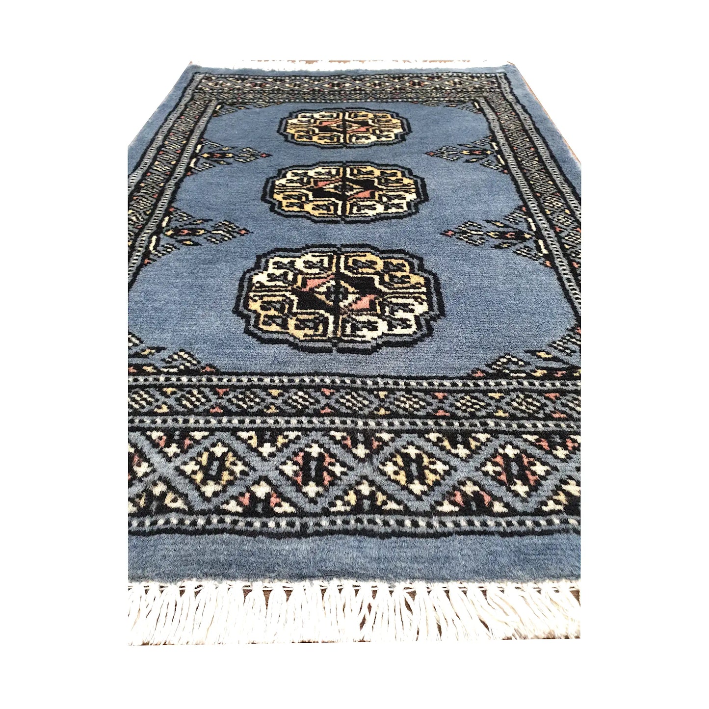 Blue-grey field and border detail of Afghan Bokhara wool rug showing three ivory gul medallions and geometric border