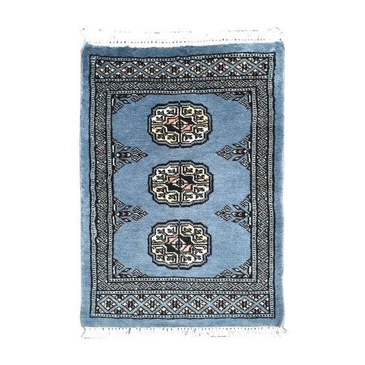 Afghan Bokhara wool rug 67 x 47 cm full view with blue-grey field, ivory gul medallions and fringe