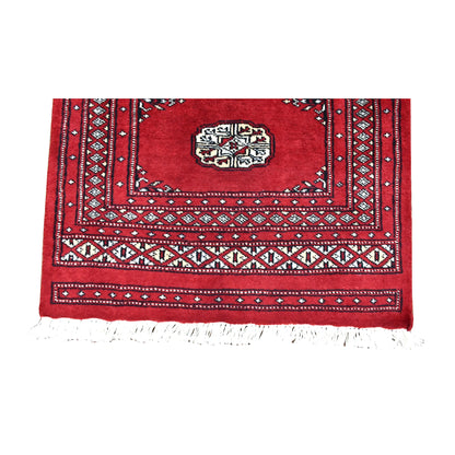 End-border detail of Bokhara runner with ivory diamond motifs, narrow geometric bands and white fringe