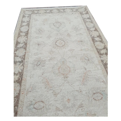 End detail of Afghan Chobi beige floral runner showing border and floral pattern