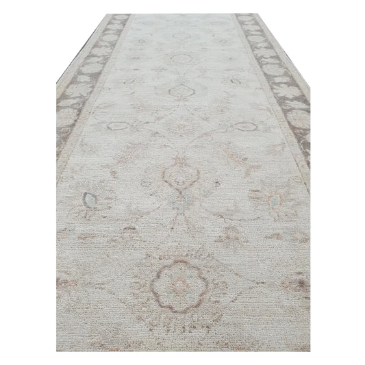 Field detail of Afghan Chobi beige floral runner showing soft wool pile and motifs