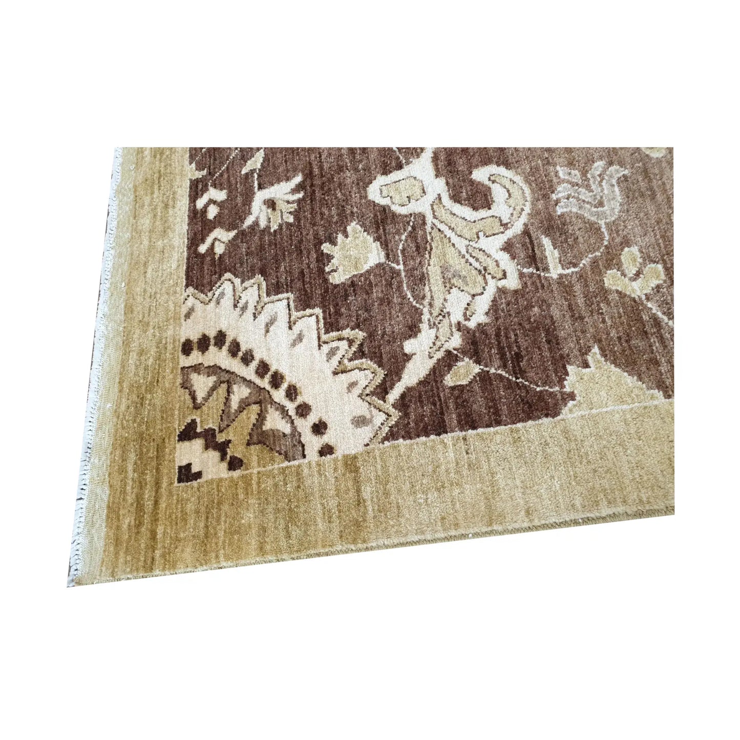 Corner detail of Afghan Chobi brown floral rug showing border and wool pile texture
