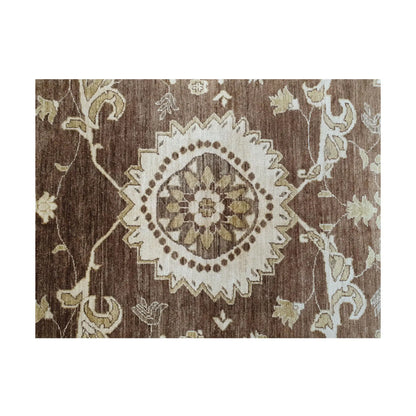 Floral detail of Afghan Chobi brown rug showing beige and ivory wool motifs