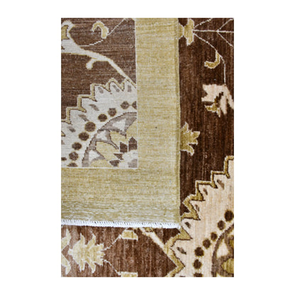 Folded-corner detail of Afghan Chobi rug showing the reverse weave beside its brown floral front and muted-gold border