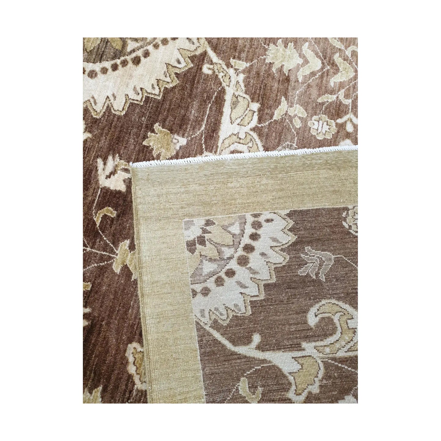 Folded edge detail of Afghan Chobi brown floral rug showing backing and border texture