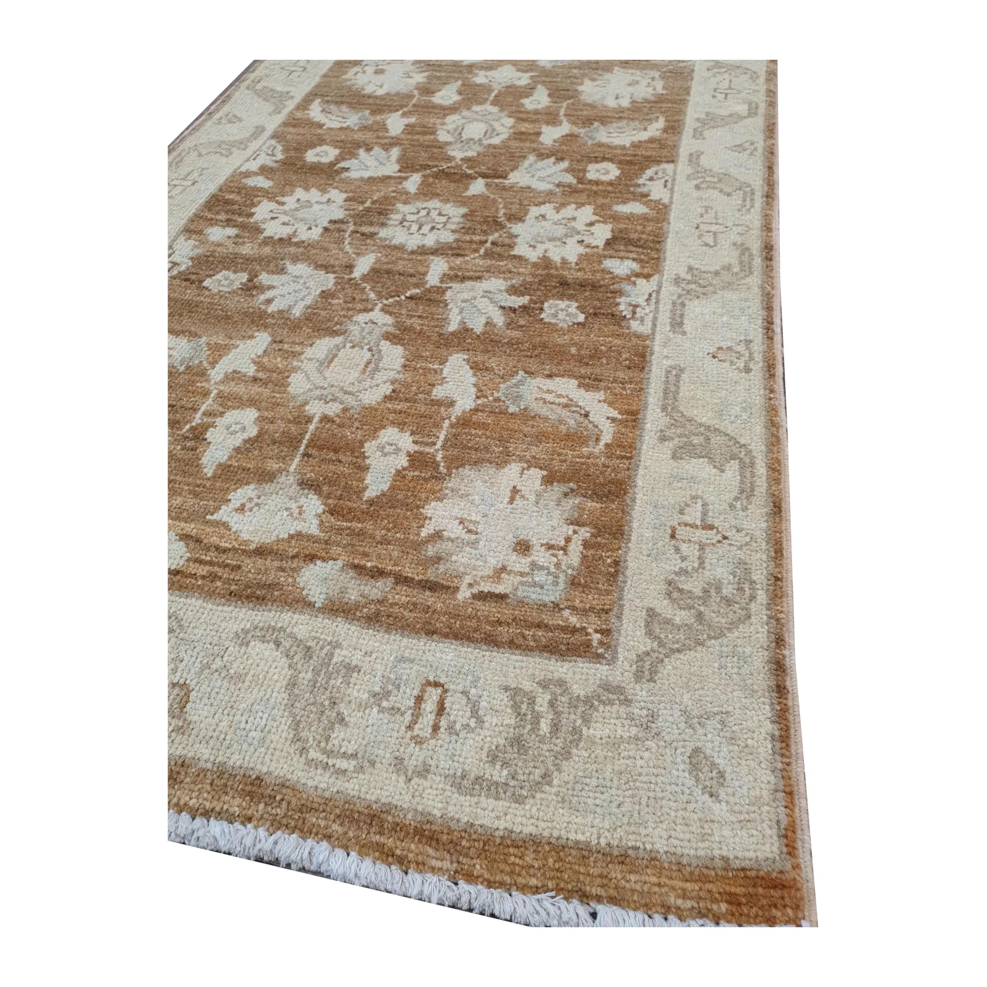 Border detail of Afghan Chobi brown medallion rug showing wool pile and floral pattern