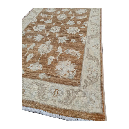 Border detail of Afghan Chobi brown medallion rug showing wool pile and floral pattern