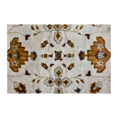 Close-up of the Chobi rug’s central floral axis with ochre palmettes, blossoms and curling brown stems