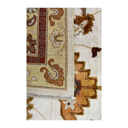 Folded-corner detail of Afghan Chobi rug showing the reverse weave beside its ivory floral front and white fringe